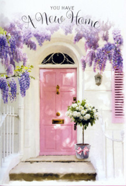 The image shows a tranquil front doorway that looks as if it belongs on a leafy Hanwell side street, perhaps just off the Uxbridge Road, where old houses wear their colours with soft pride. A blush-pink door stands in the centre, its paint smooth and matte, catching light in gentle, powdery highlights rather than a harsh shine. Around it, whitewashed walls and a pale, simple shutter create a clean, almost coastal backdrop that lets the flowers take centre stage. Above the frame, wisteria flows in generous cascades of lavender and dusty lilac, the blossoms hanging in layered clusters that feel both wild and carefully trained, as though tended over years by a devoted gardener. Each strand drapes down like a beaded curtain, forming a fragrant canopy that seems to soften every sound and movement near the entrance. At ground level, a galvanized-style grey bucket sits snugly by the threshold, brimming with garden-fresh white and cream roses. Their petals are thick and luxurious, spiralling out in soft, sculpted layers that invite you to lean in and breathe deeply. Between the roses, small shoots of fresh greenery peek out, in calm, sage-like tones that balance the arrangement and add depth. Around the bucket's base, a silky pink ribbon is tied with understated precision, its colour subtly mirroring the door and giving the whole arrangement a sense of thoughtful completion. Sunlight seeps in from the side, turning the roses' edges almost translucent and scattering delicate, dappled shadows onto the steps. The atmosphere feels like the gentle pause before friends arrive with keys in hand, the flowers standing ready to congratulate them on their new Hanwell home with a hushed, floral blessing.